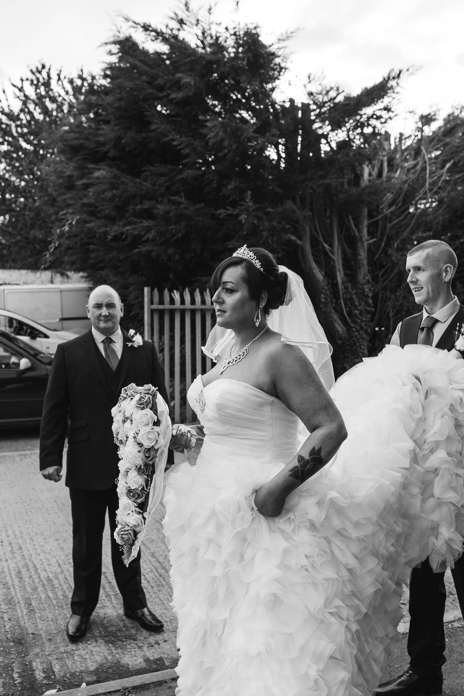 beautiful bride waits expectedly for the bridal car to arrive