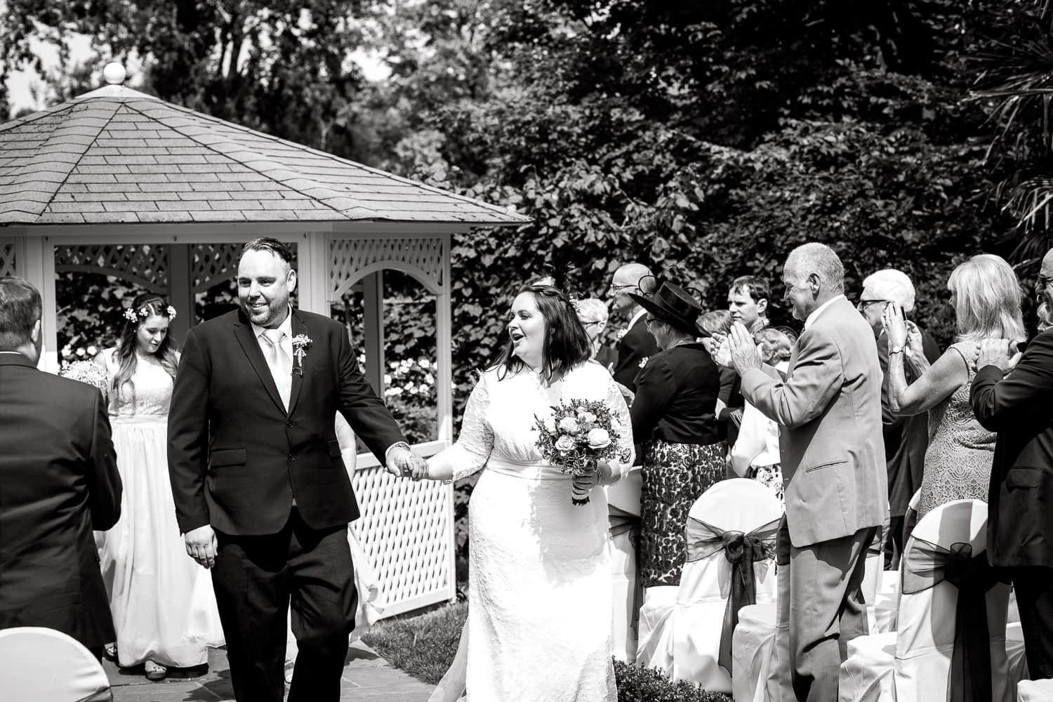 bride and groom walk up the aisle after warwick house wedding