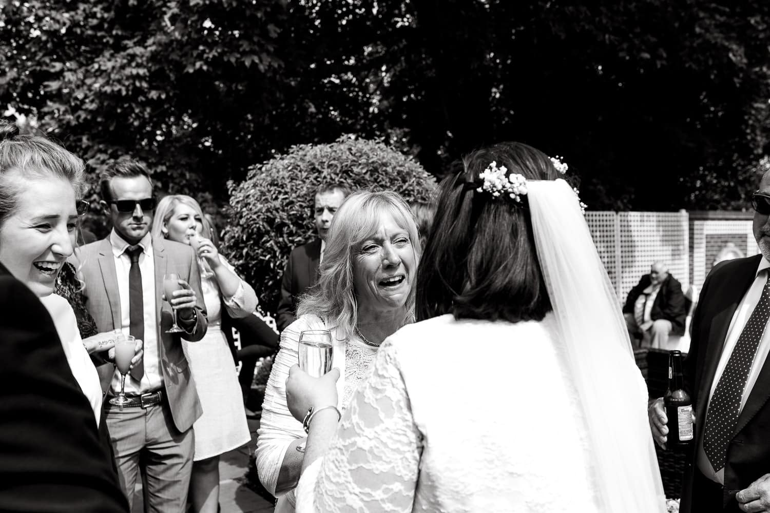 emotional guests congratulates bride during wedding at warwick house wedding in UK
