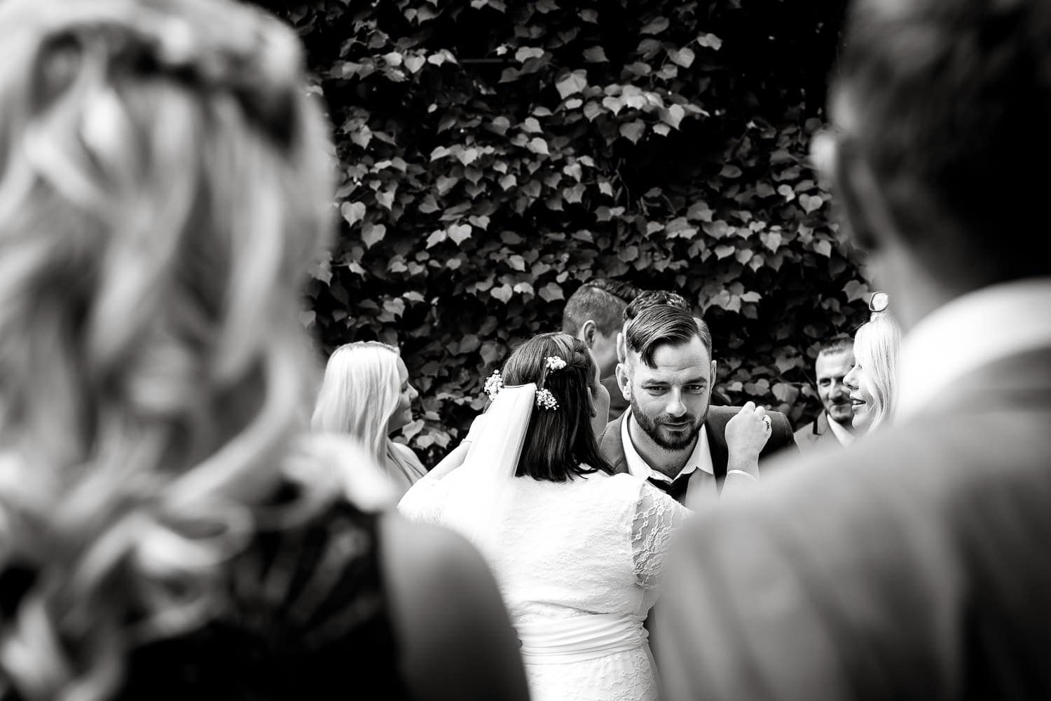 candid of guests in mono at warwick house wedding in warks