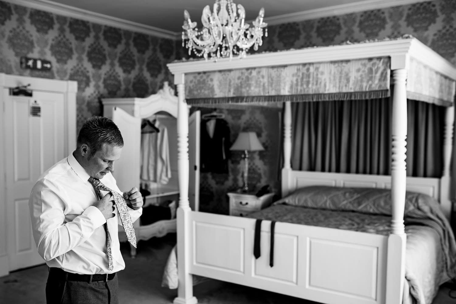 Warwick House Wedding Photography captures warwickshire groom doing tie