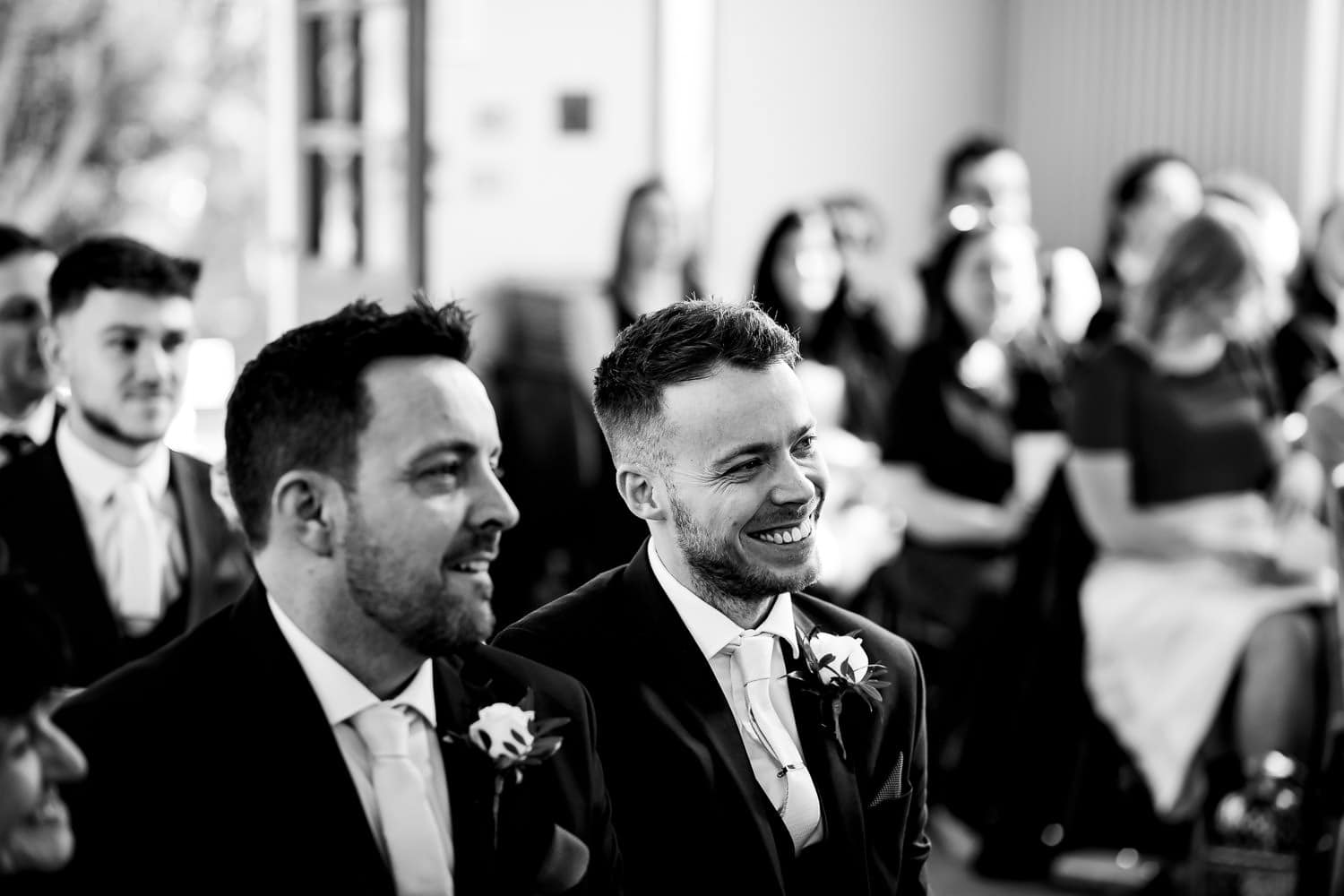 Grooms party smiling during wedding ceremony in Leicestershire