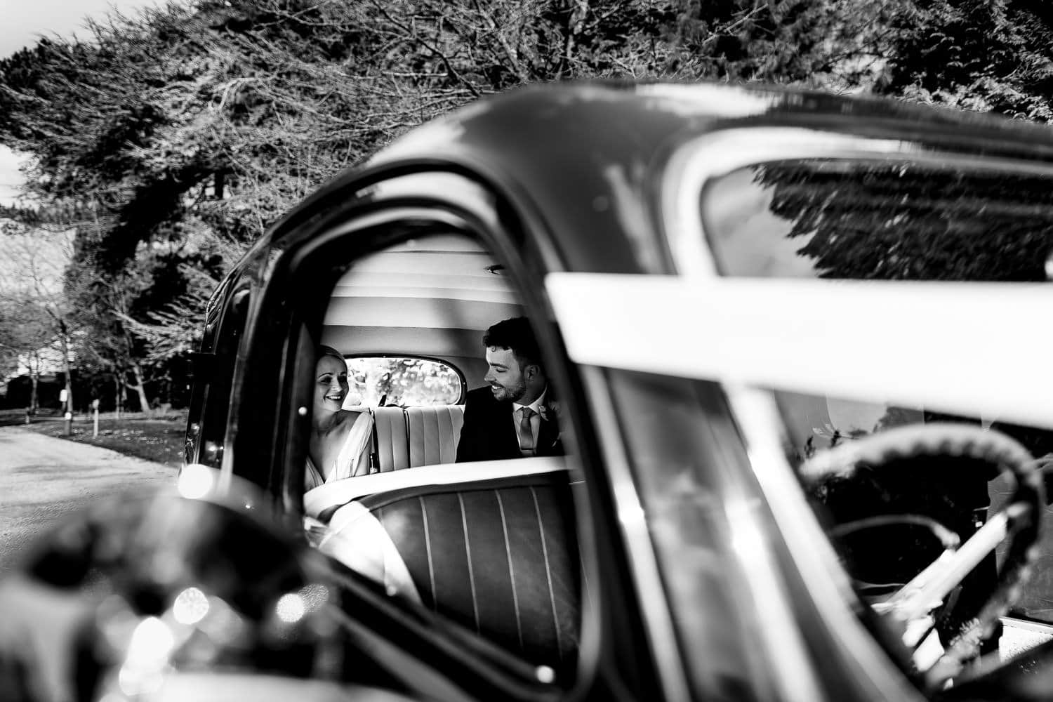 Bride and groom inside their wedding car at The Pumping Station in Cropston - Leicestershire