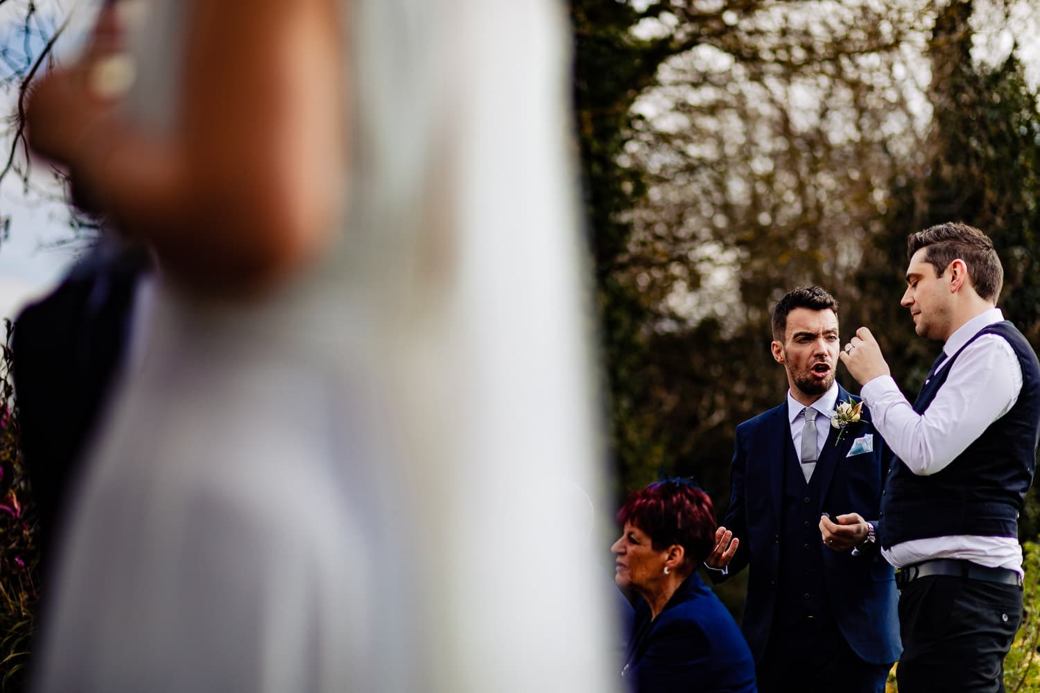 Groom talks with wedding guests during the wedding reception at The Old Stables Swithland