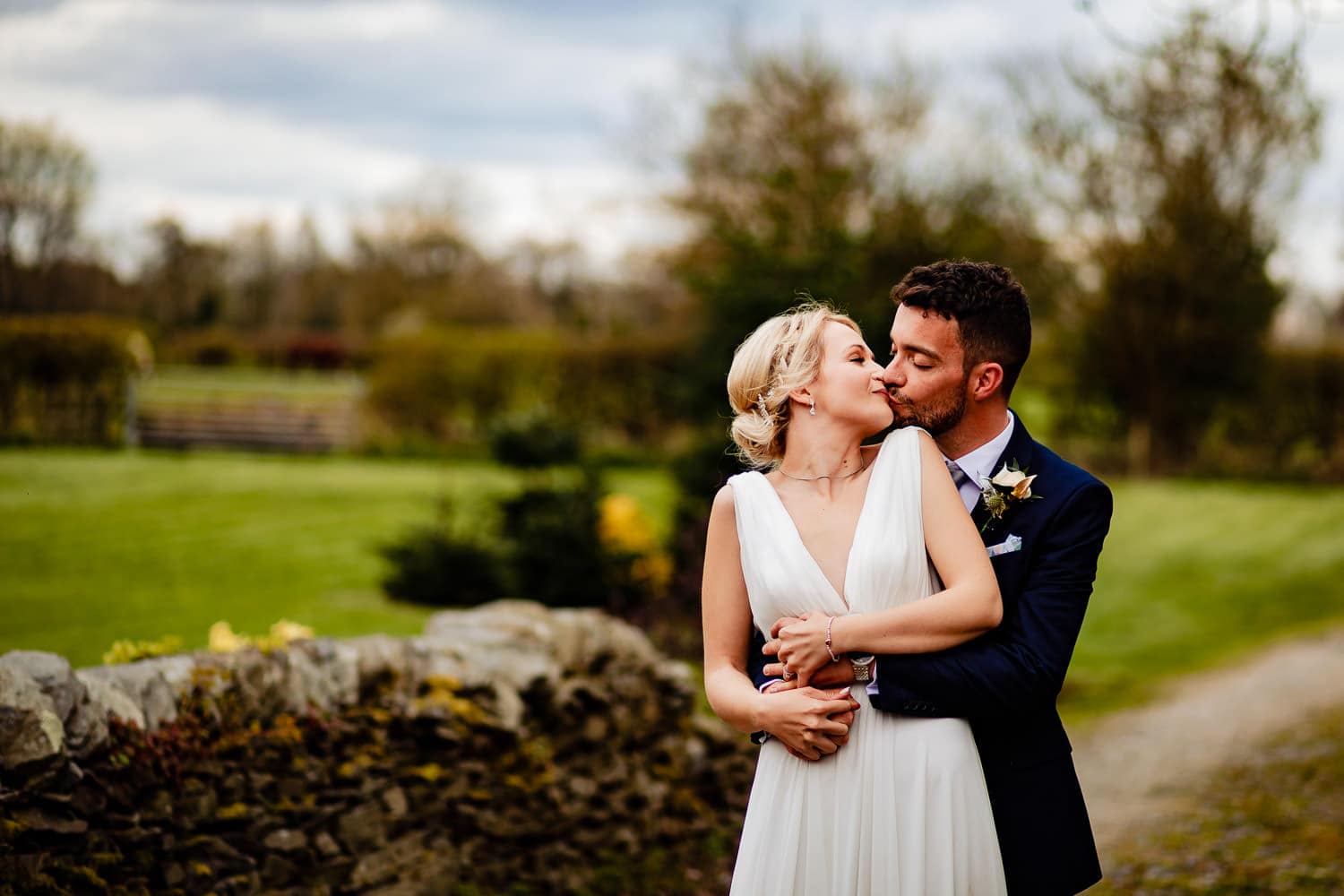 Bride and groom kiss during wedding portraits in Leicestershire countryside - captured by Chapter One Photography